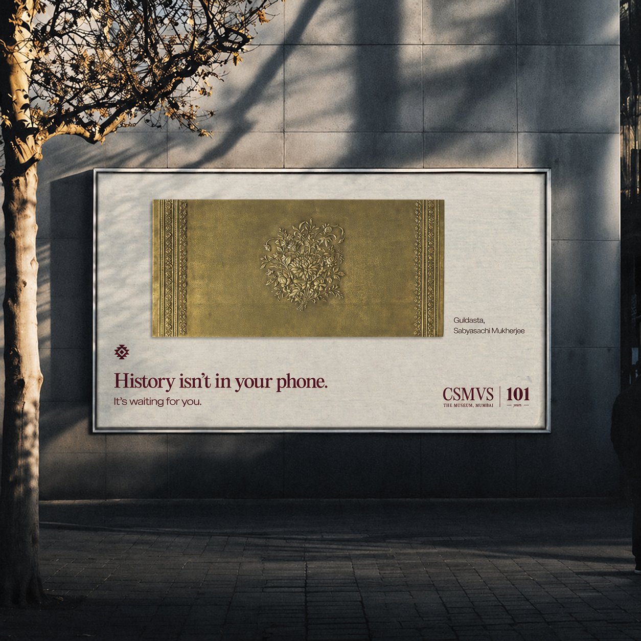 Billboard reading 'History isn't in your phone. It's waiting for you.' featuring the Guldasta artwork by Sabyasachi Mukherjee