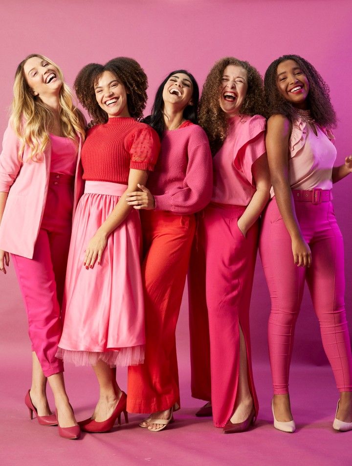Five women laughing and celebrating together